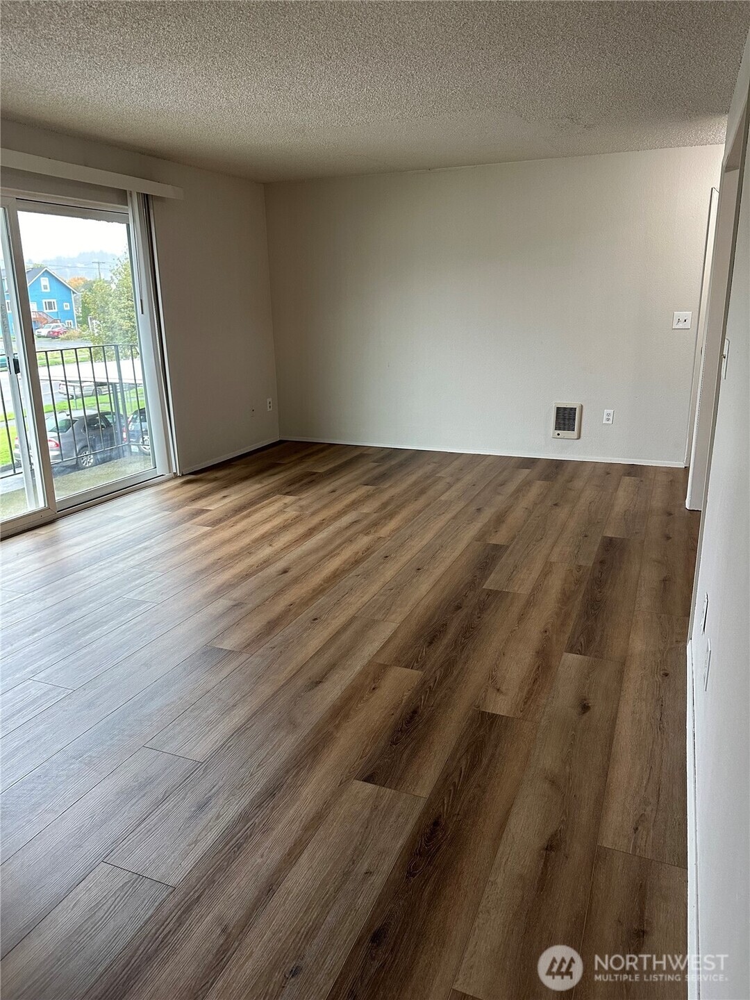 1111 West Market Street Aberdeen, WA 98520 - Photo 9 of 40 an empty room with wooden floor and windows