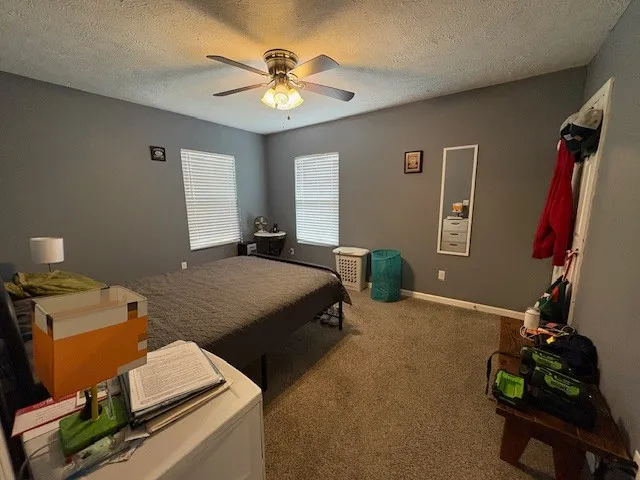 a bedroom with bed and a chandelier