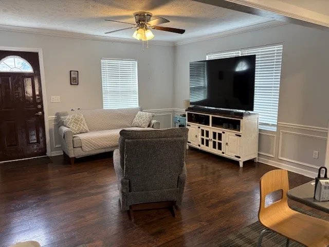 a living room with furniture and a flat screen tv