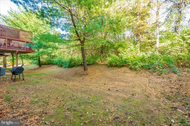 a view of a backyard with a table and chairs