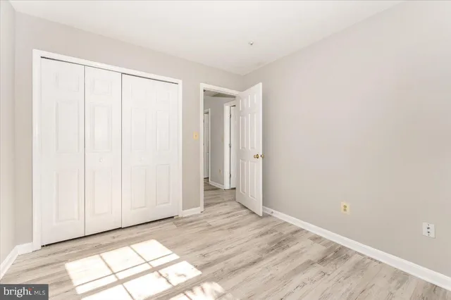 a view of a room with wooden floor and entryway