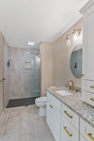 a living room with a fireplace and a ceiling fan