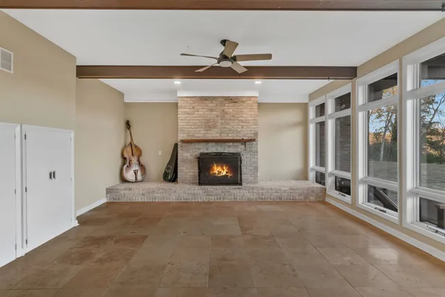 a view of room with window and wooden floor