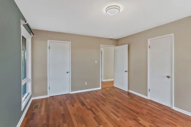a view of a room with wooden floor