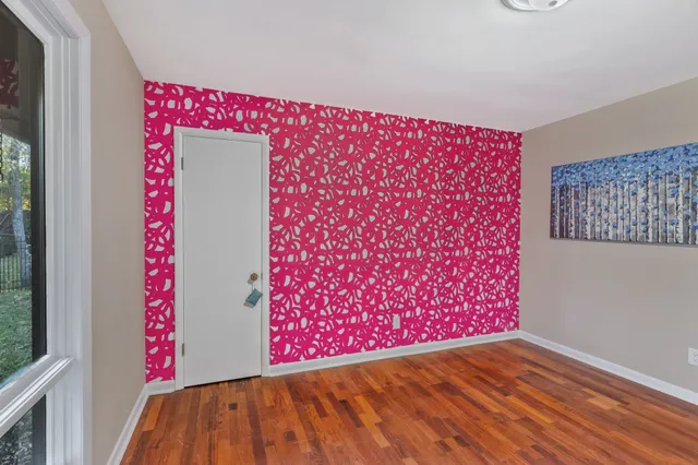 a view of a house with a yard and a tree