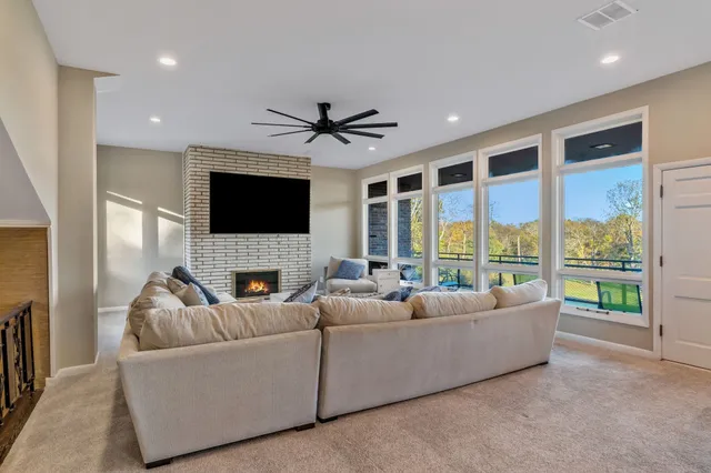 a living room with furniture and a floor to ceiling window