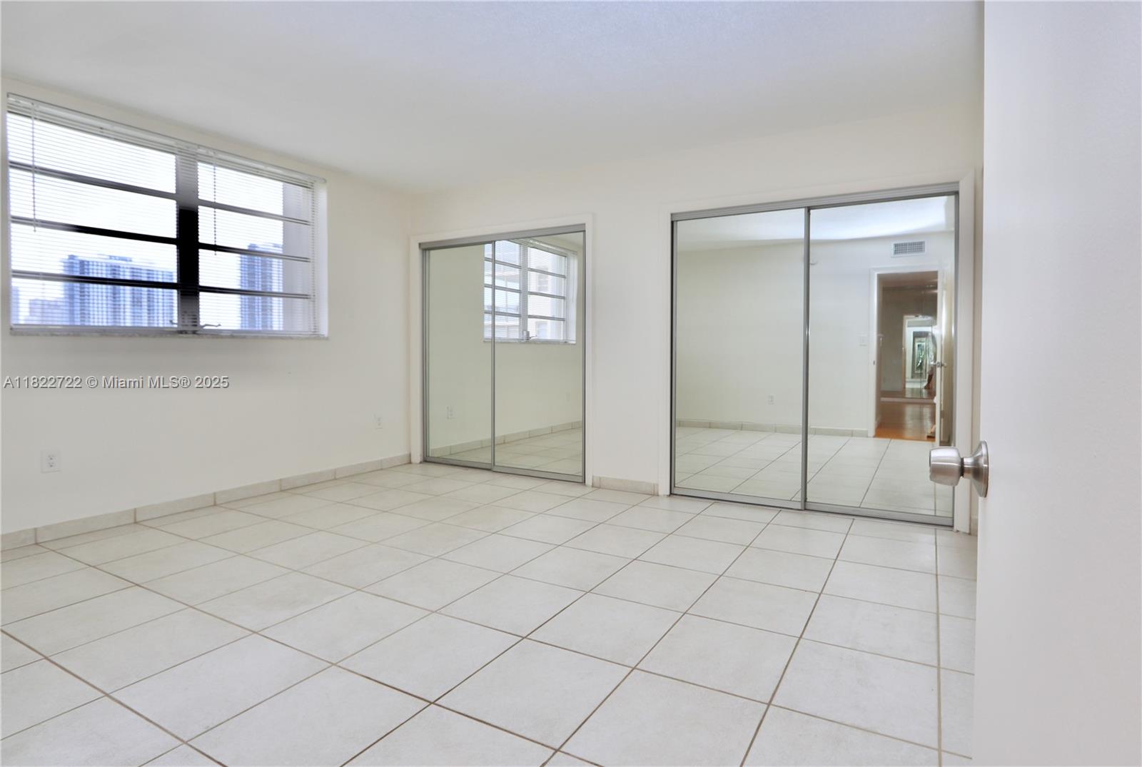 2920 Point E Drive, Unit N208 Aventura, FL 33160 - Photo 14 of 34 an empty room with windows and closet