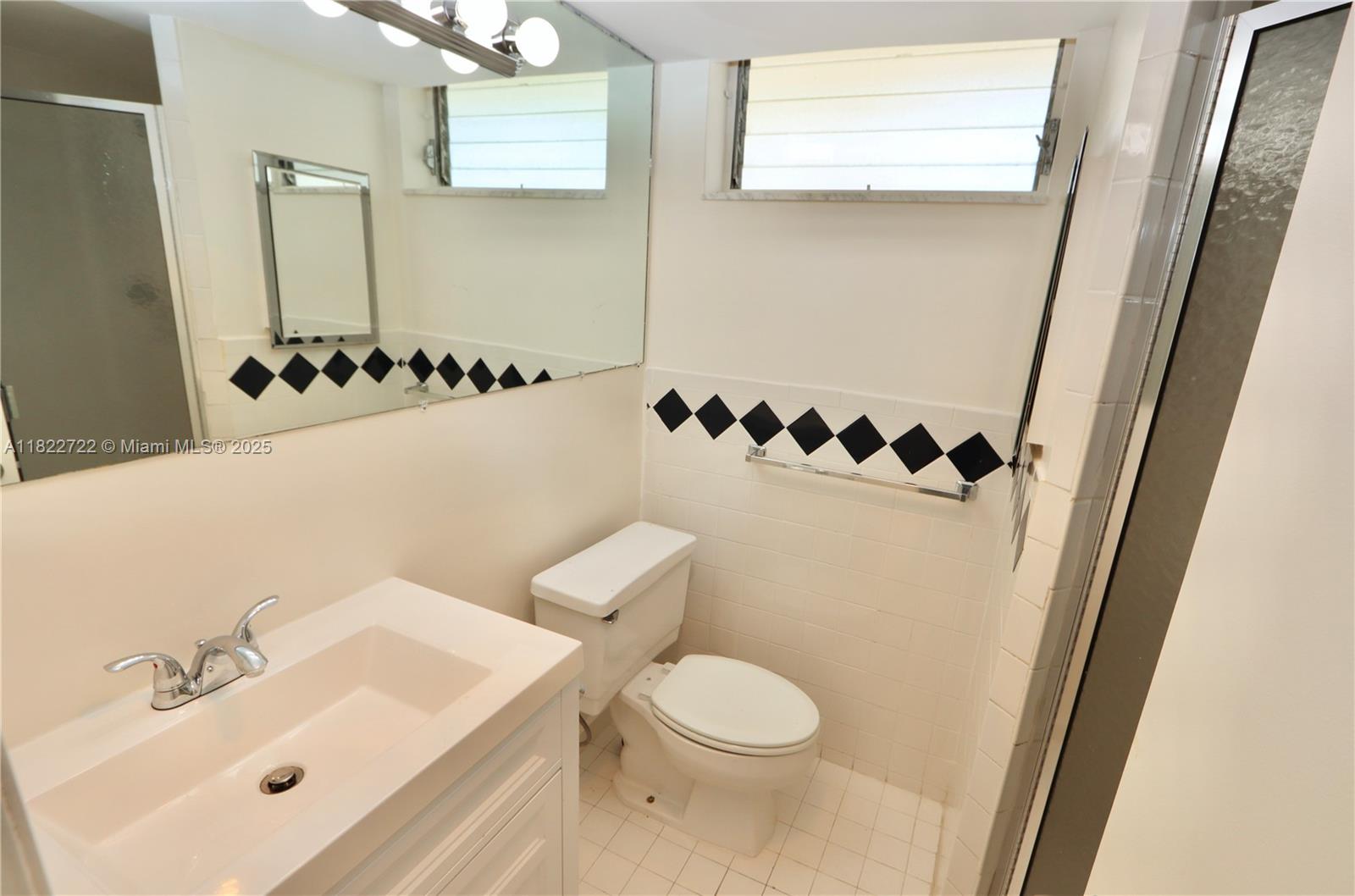 2920 Point E Drive, Unit N208 Aventura, FL 33160 - Photo 15 of 34 a bathroom with a sink and a mirror