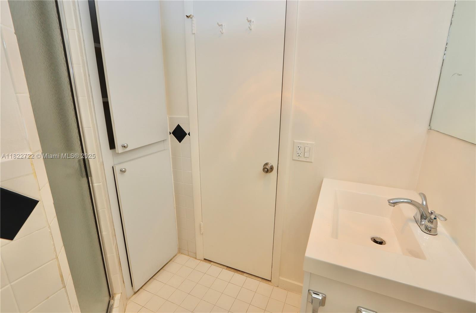 2920 Point E Drive, Unit N208 Aventura, FL 33160 - Photo 16 of 34 a bathroom with a sink and a mirror