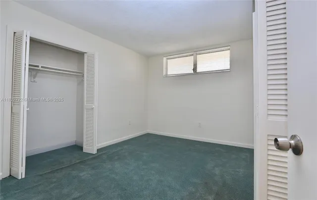 a hallway with dining table and chairs