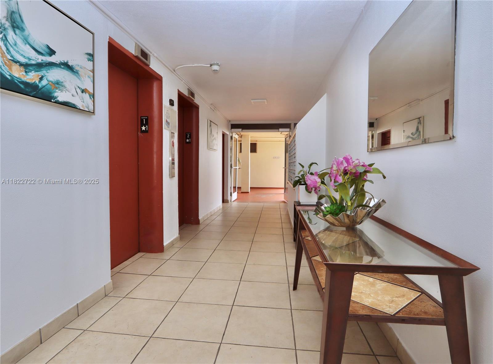 2920 Point E Drive, Unit N208 Aventura, FL 33160 - Photo 23 of 34 a hallway with wooden floor and a potted plant