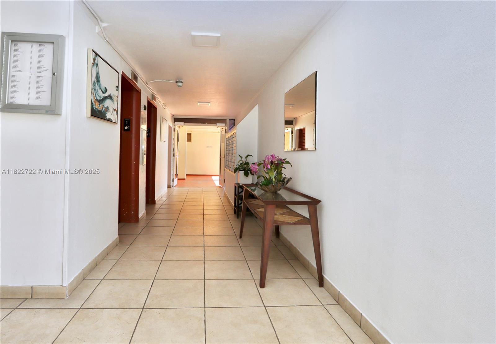 2920 Point E Drive, Unit N208 Aventura, FL 33160 - Photo 24 of 34 a hallway with dining table and chairs