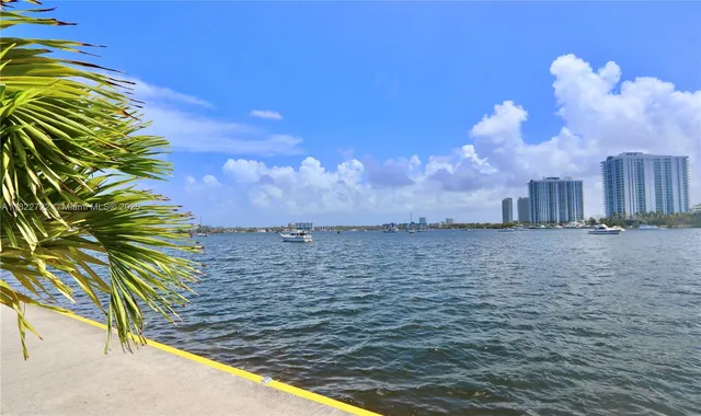 a view of a tall building next to a yard