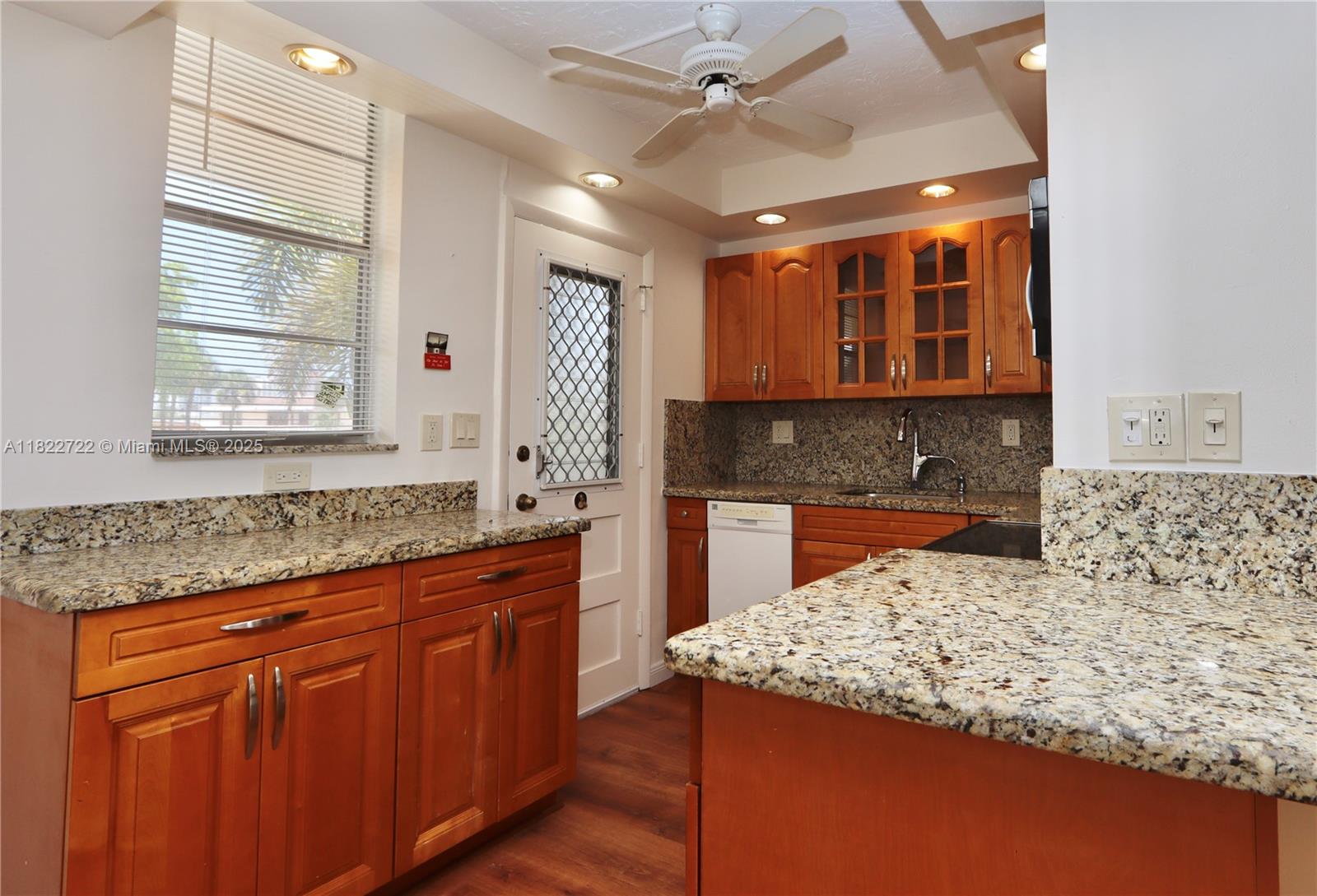 2920 Point E Drive, Unit N208 Aventura, FL 33160 - Photo 4 of 34 a kitchen with stainless steel appliances granite countertop wooden cabinets and a granite counter tops