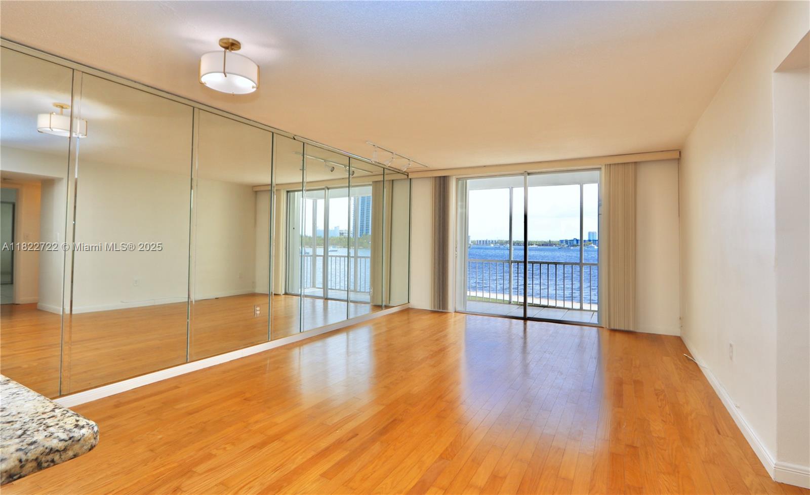 2920 Point E Drive, Unit N208 Aventura, FL 33160 - Photo 6 of 34 a view of an empty room with wooden floor and a window