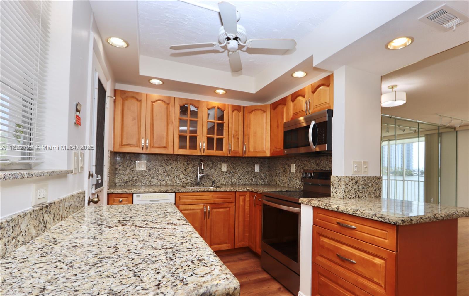 2920 Point E Drive, Unit N208 Aventura, FL 33160 - Photo 8 of 34 a kitchen with stainless steel appliances granite countertop a sink stove and cabinets