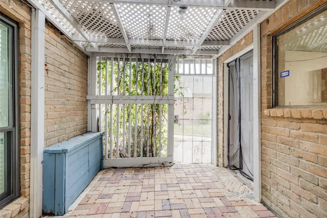 a view of a large room with wooden floor and windows