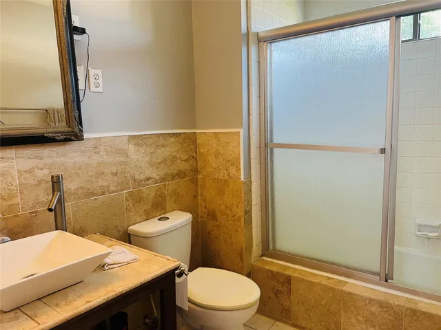 a bathroom with a tub sink and toilet