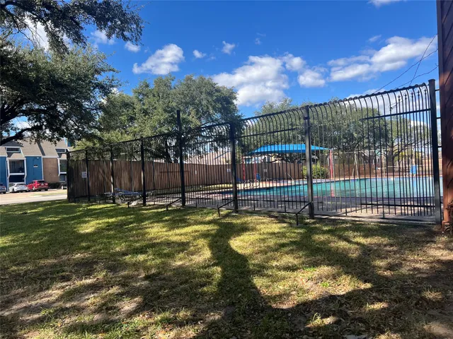 a view of a swimming pool with a yard