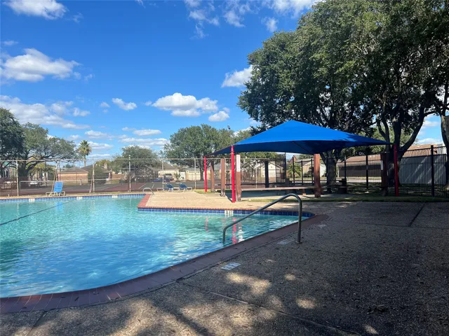 a view of a swimming pool with a yard
