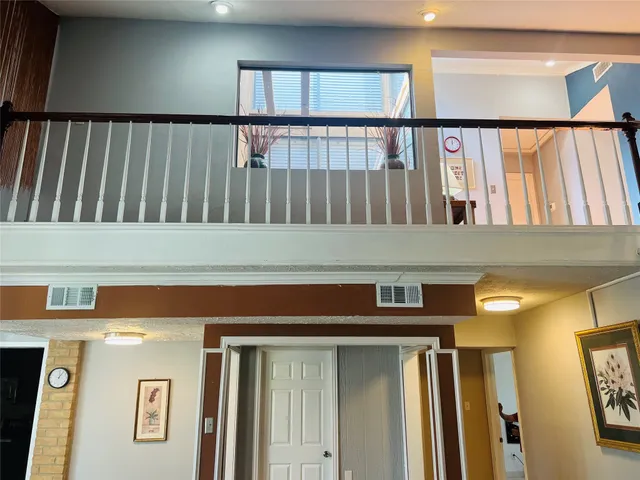 a living room with furniture wooden floor and a large window
