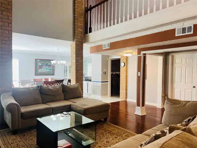 a view of stairs and hall with wooden floor