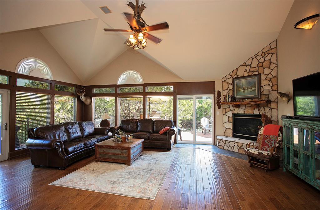 880 Cliffs Drive Graford, TX 76449 - Photo 11 of 40 a living room with furniture a flat screen tv and a fireplace