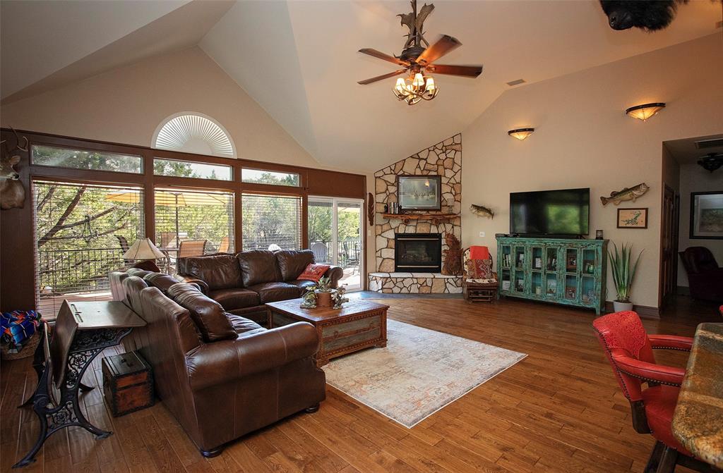 880 Cliffs Drive Graford, TX 76449 - Photo 12 of 40 a living room with furniture a flat screen tv and a large window