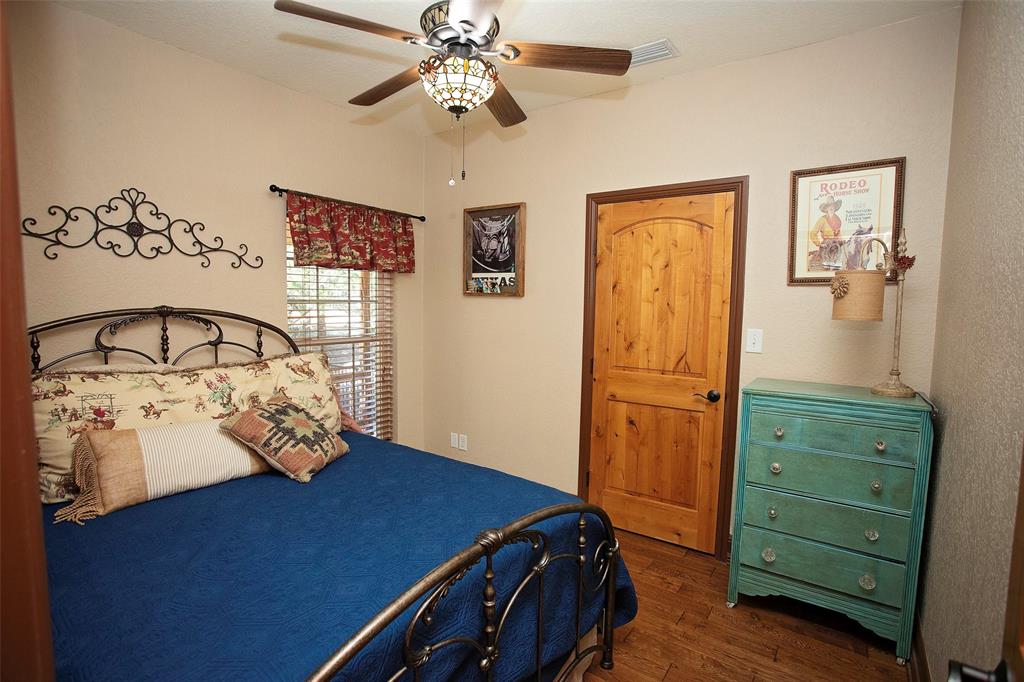 880 Cliffs Drive Graford, TX 76449 - Photo 13 of 40 a bedroom with a bed and a dresser