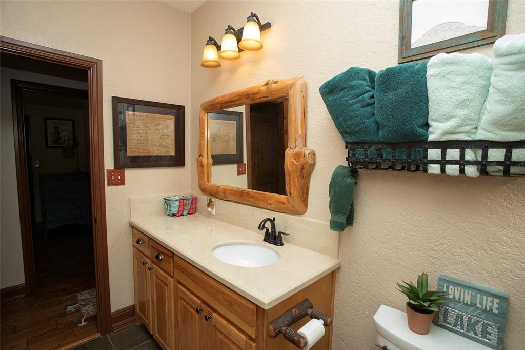 880 Cliffs Drive Graford, TX 76449 - Photo 16 of 40 a bathroom with a sink and a mirror