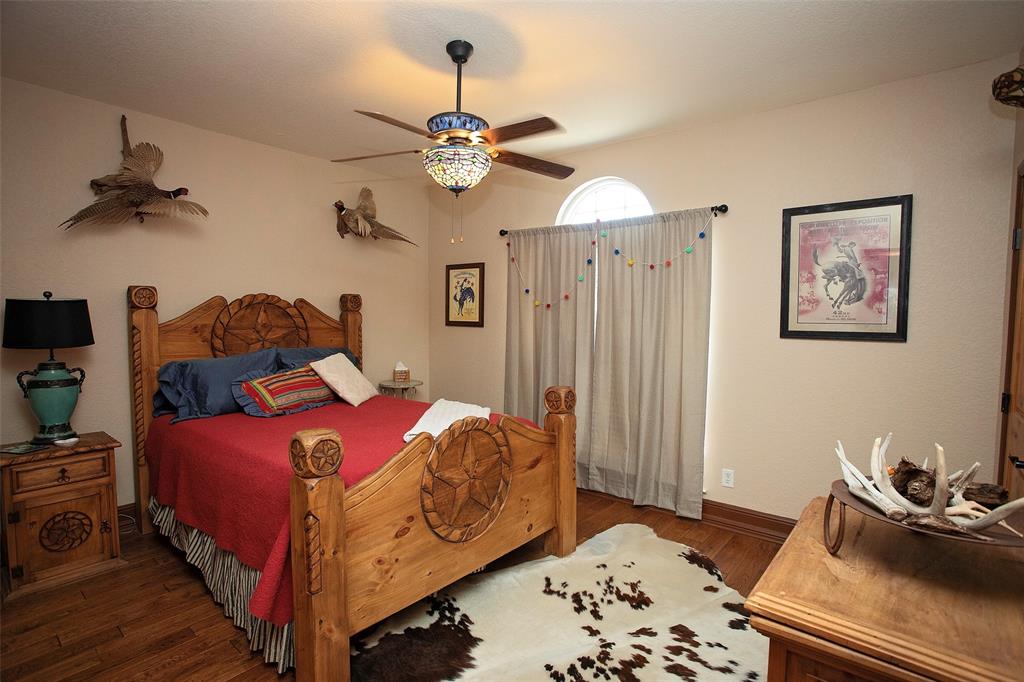 880 Cliffs Drive Graford, TX 76449 - Photo 17 of 40 a bedroom with bed and furniture