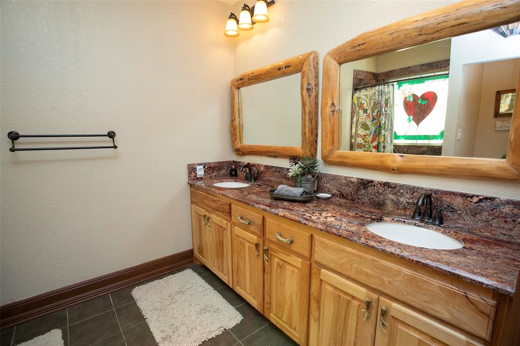 880 Cliffs Drive Graford, TX 76449 - Photo 26 of 40 a bathroom with a sink and a mirror
