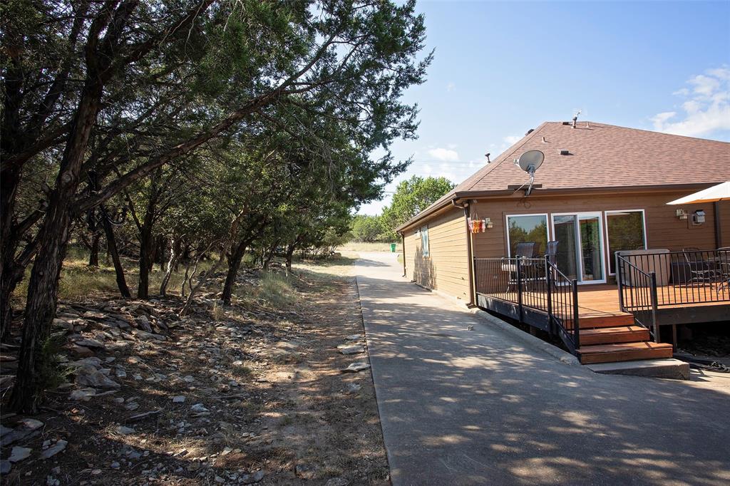 880 Cliffs Drive Graford, TX 76449 - Photo 28 of 40 a view of a house with a yard