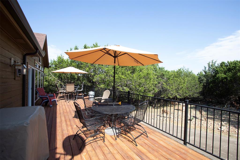 880 Cliffs Drive Graford, TX 76449 - Photo 29 of 40 a view of balcony with furniture and umbrella