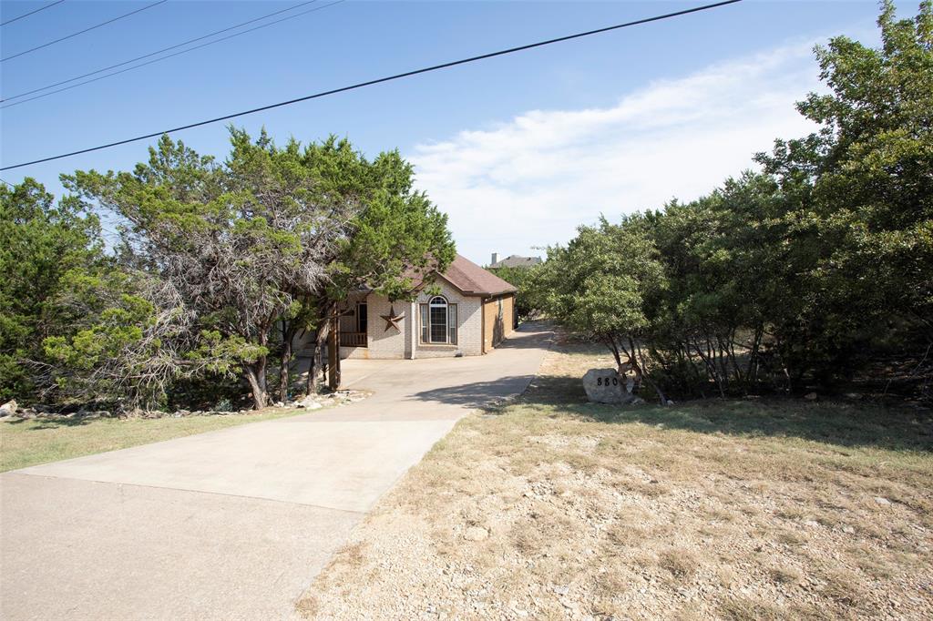 880 Cliffs Drive Graford, TX 76449 - Photo 4 of 40 a view of a yard with a house