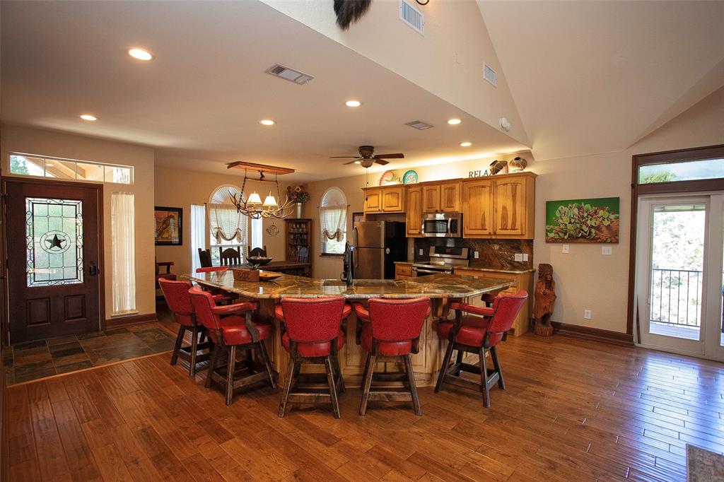 880 Cliffs Drive Graford, TX 76449 - Photo 7 of 40 a dining room with stainless steel appliances lots of wooden furniture
