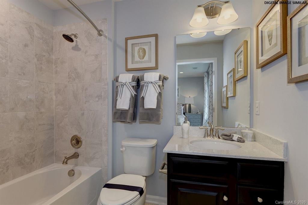 7123 Messina Road, Unit 130 Indian Land, SC 29707 - Photo 13 of 15 a bathroom with a sink a toilet and shower