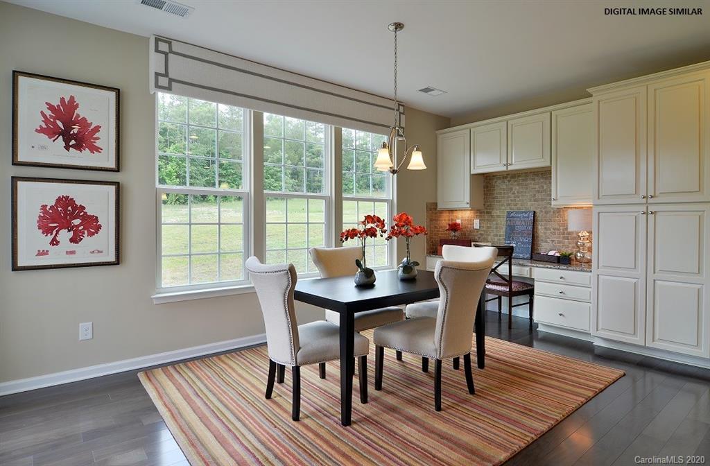 7123 Messina Road, Unit 130 Indian Land, SC 29707 - Photo 5 of 15 a view of a dining room with furniture window and wooden floor