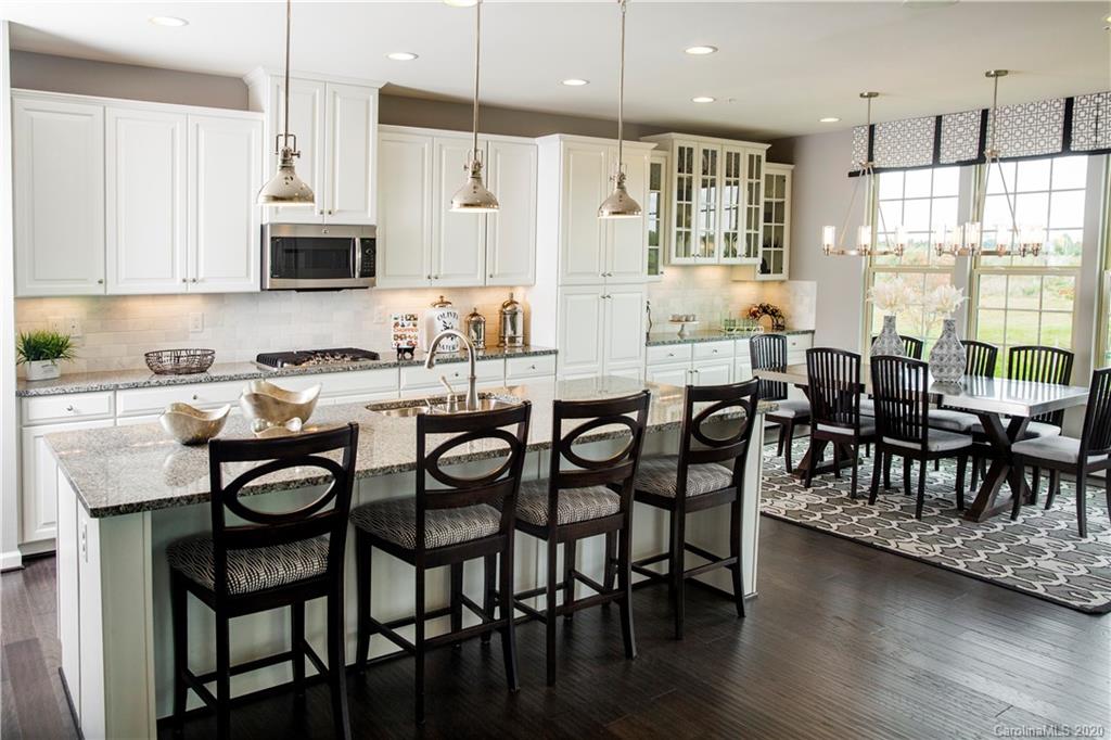 7123 Messina Road, Unit 130 Indian Land, SC 29707 - Photo 6 of 15 a dining table with chairs and wooden floor