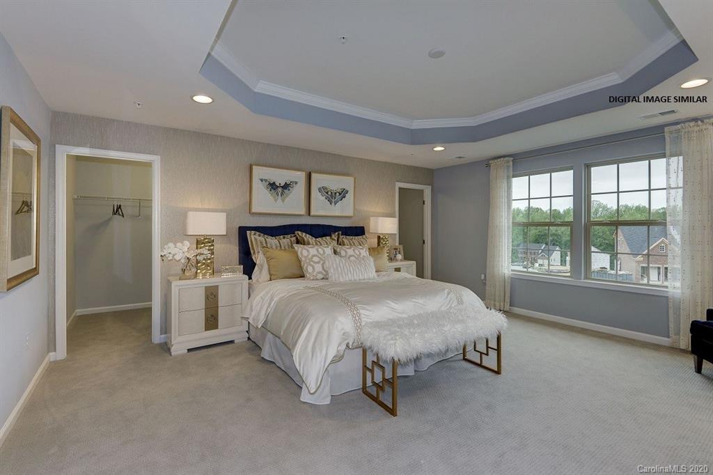 7123 Messina Road, Unit 130 Indian Land, SC 29707 - Photo 8 of 15 a bedroom with a bed and a large window