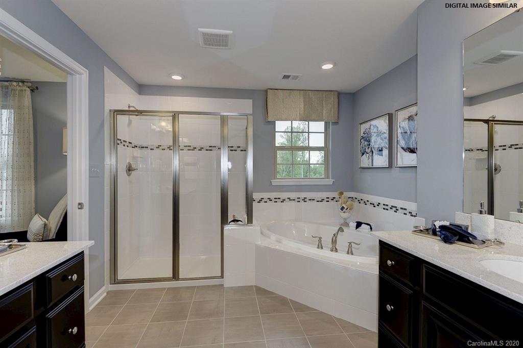 7123 Messina Road, Unit 130 Indian Land, SC 29707 - Photo 9 of 15 a bathroom with a tub sink shower and mirror