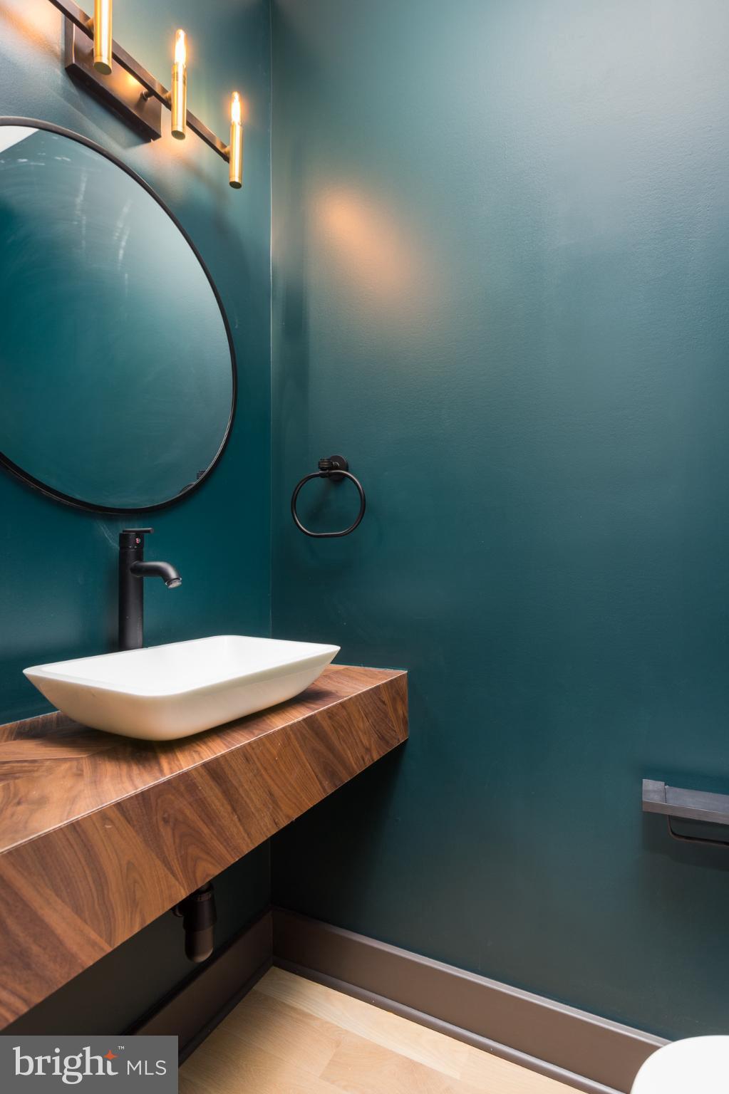 1610 Baltimore Road Alexandria, VA 22308 - Photo 32 of 45 Sleek modern bathroom with bold teal walls.