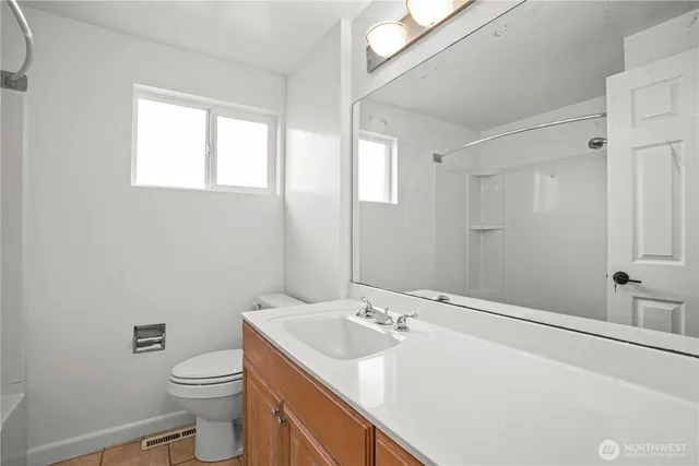 a bathroom with a sink toilet vanity and a mirror