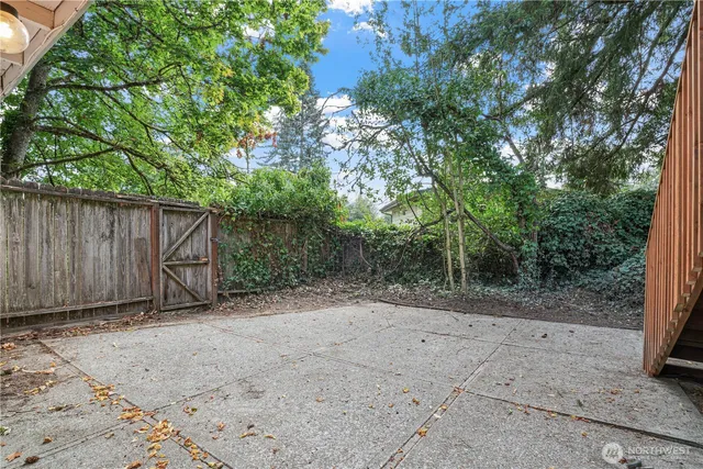 a view of backyard with wooden fence