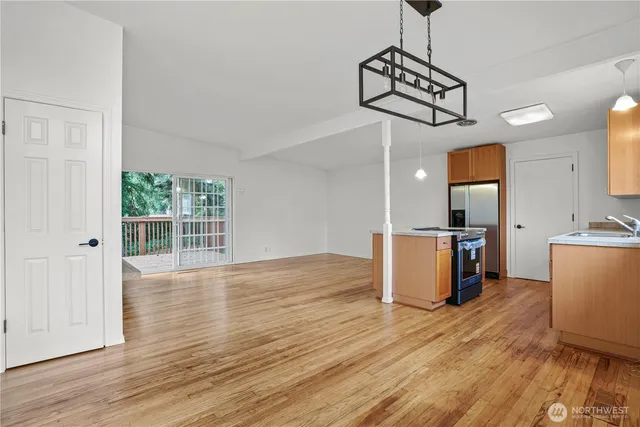 a view of a room with wooden floor and windows