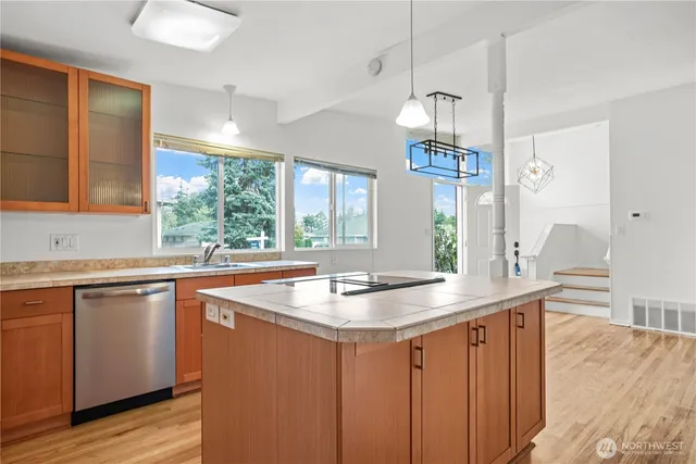 a kitchen with a sink and wooden cabinets