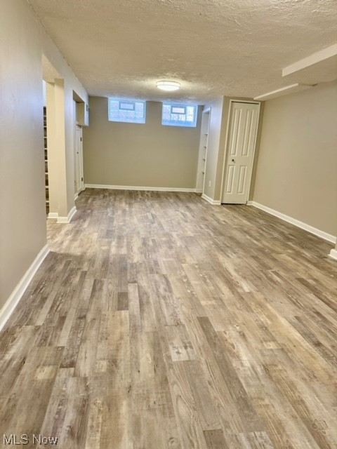 1508 Winchester Road Lyndhurst, OH 44124 - Photo 19 of 23 Basement with wood-type flooring and a textured ceiling