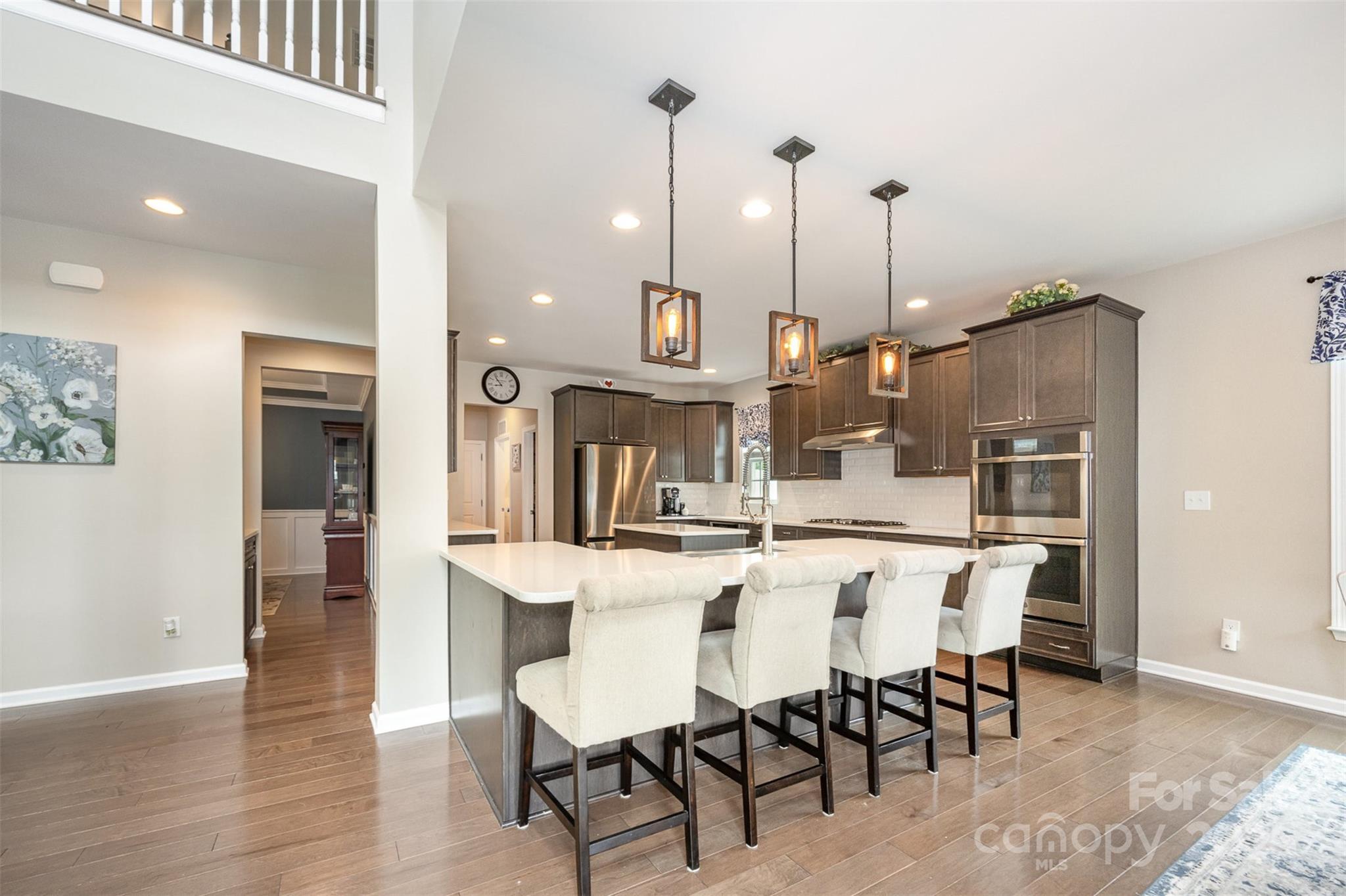 2960 Haley Circle Davidson, NC 28036 - Photo 11 of 31 a dining area with stainless steel appliances kitchen island granite countertop a dining table chairs and a refrigerator