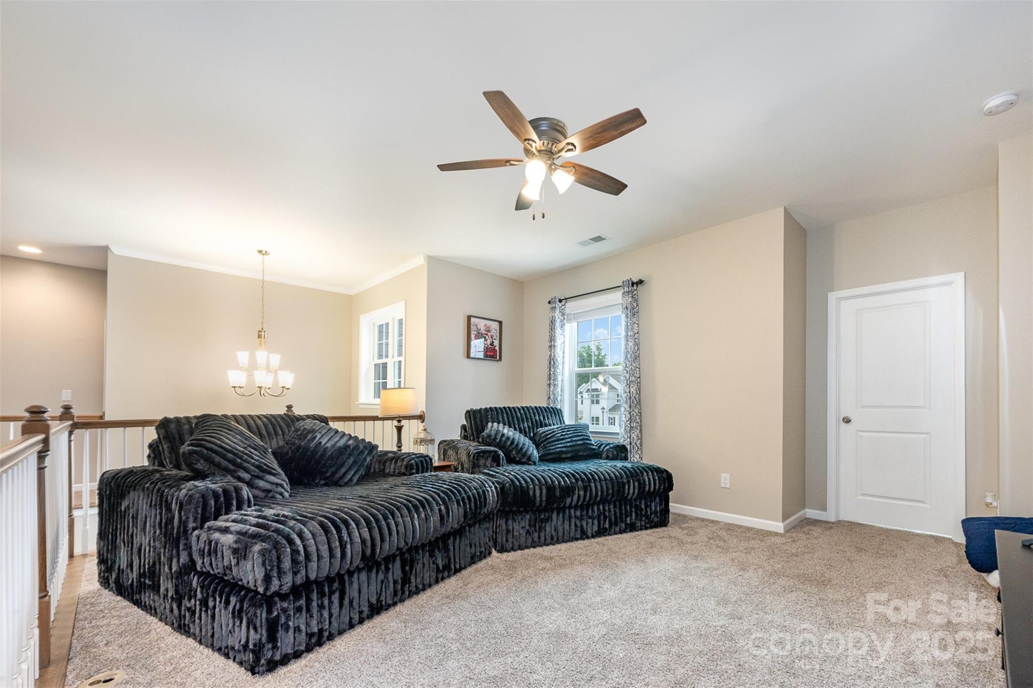 2960 Haley Circle Davidson, NC 28036 - Photo 14 of 31 a living room with furniture a ceiling fan and a window
