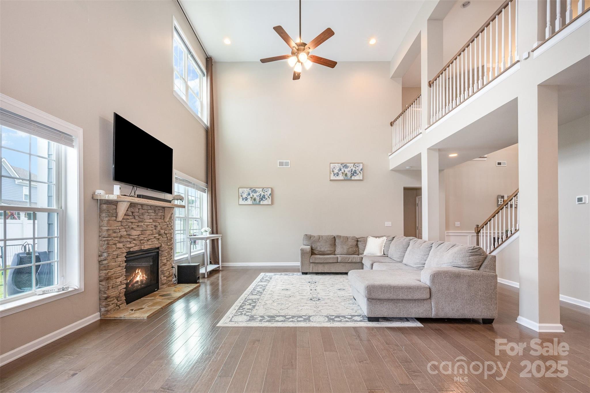 2960 Haley Circle Davidson, NC 28036 - Photo 2 of 31 a living room with furniture a fireplace and a flat screen tv